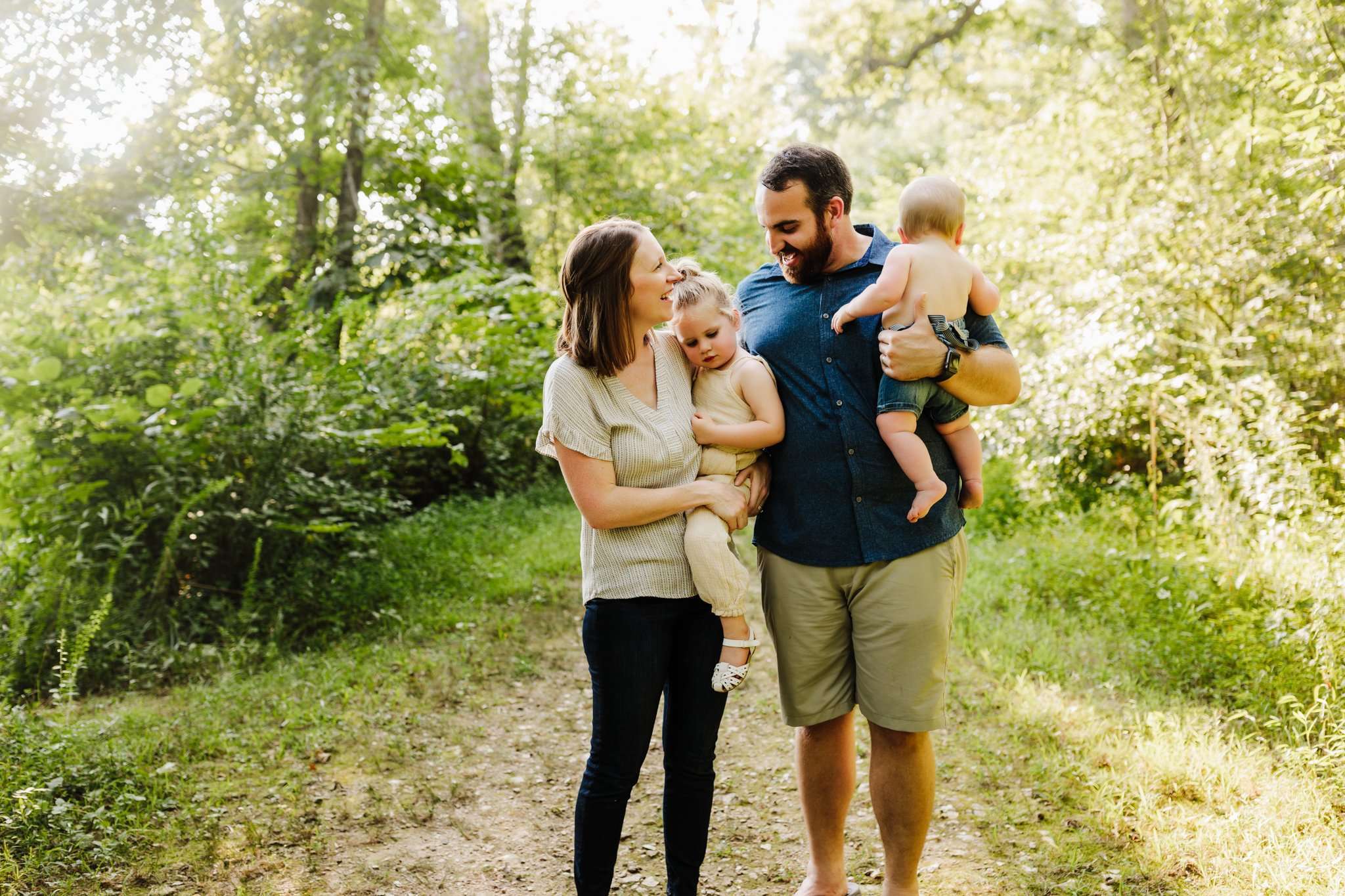 Family lovingly staring at eachother for their NWA family photography session in Cave Springs, AR